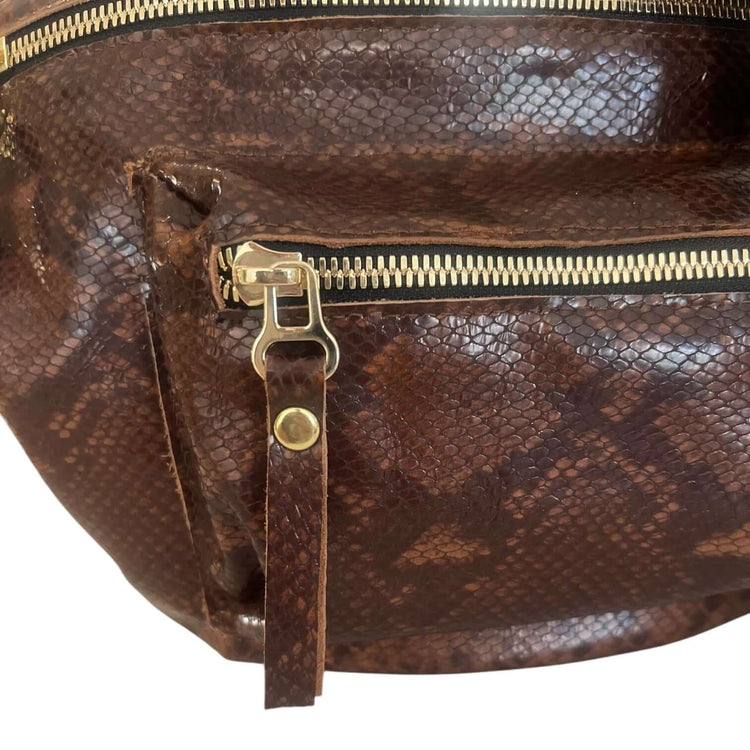 Close-up of The Joan Brown Snake Crossbody showing embossed leather and gold zipper detailing, embodying quality and beauty.