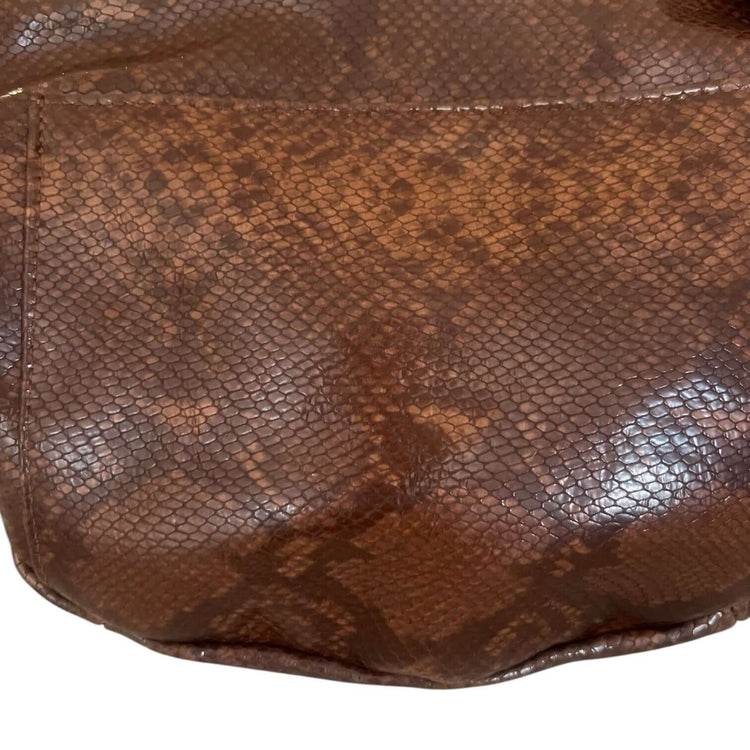Close-up of The Joan Brown Snake Crossbody, showcasing quality embossed leather and intricate design.