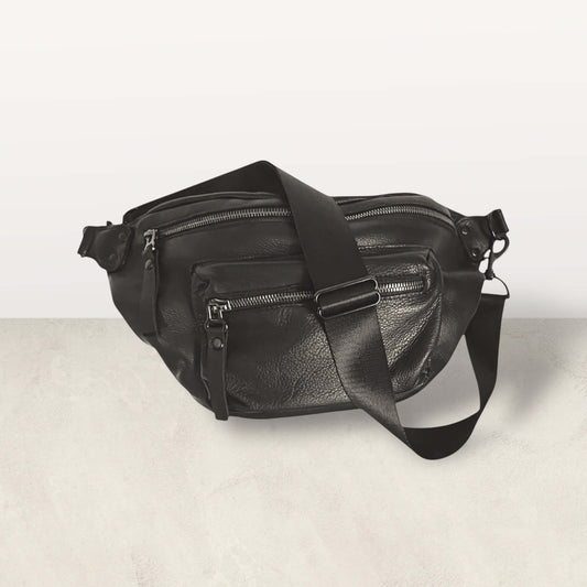 The Noir Crossbody Bag in supple black leather with multiple zipper pockets for quality and beauty, created to bring joy.