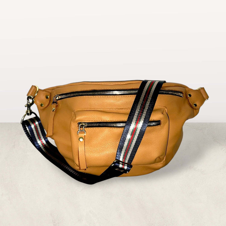 The Joan Saddle Bag in saddle supple Italian leather with gold hardware and stylish striped strap.