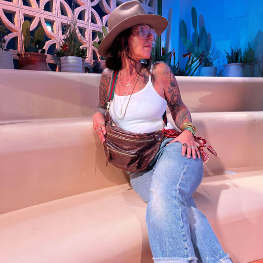 Stylish woman wearing The Joan Brown Snake Crossbody, showcasing its quality and beauty with everyday essentials.